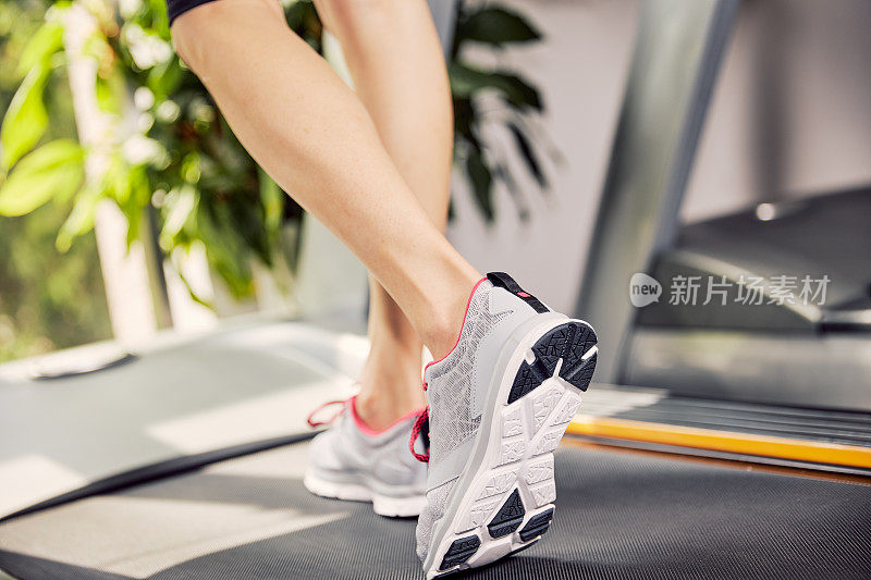 Fitness girl running on treadmill